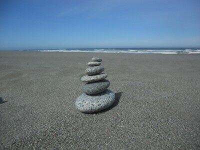 Stacking rocks at Gold Bluffs Beach Prairie Creek Redwoods state park California