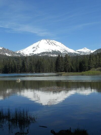 A Snowy Mount Lassen is mirrored in Manzanita Lake at Lassen volcanic National Park